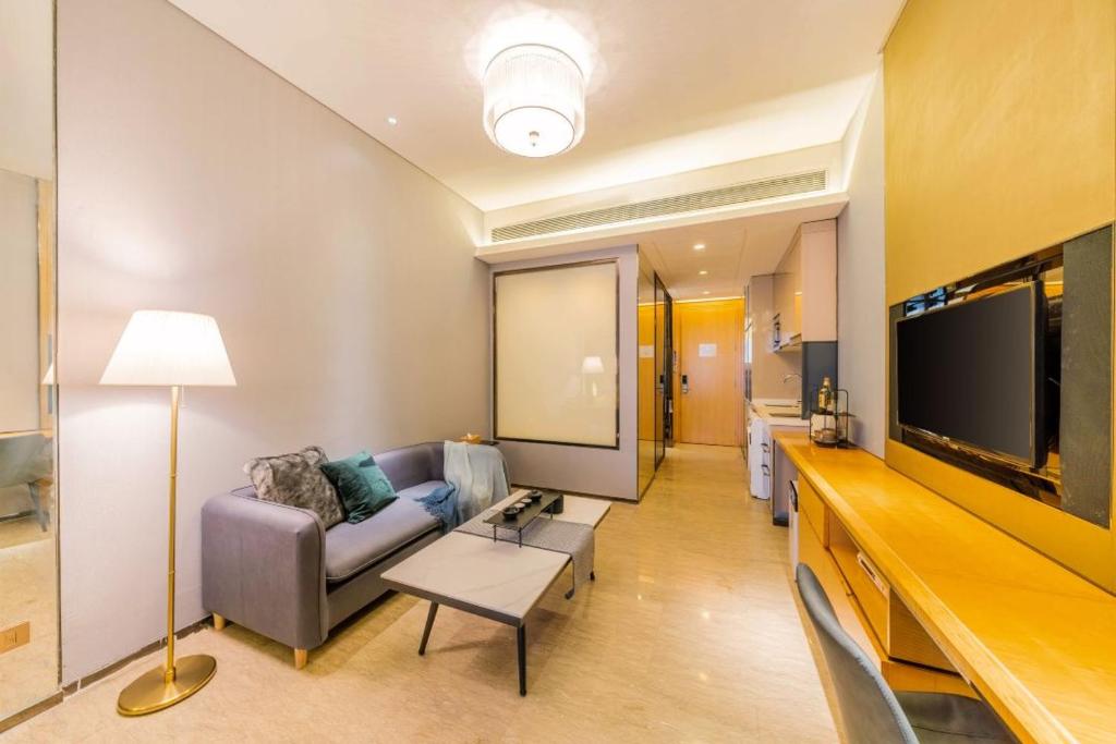 a living room with a couch and a flat screen tv at Fa万濠国际服务公寓 in Guangzhou