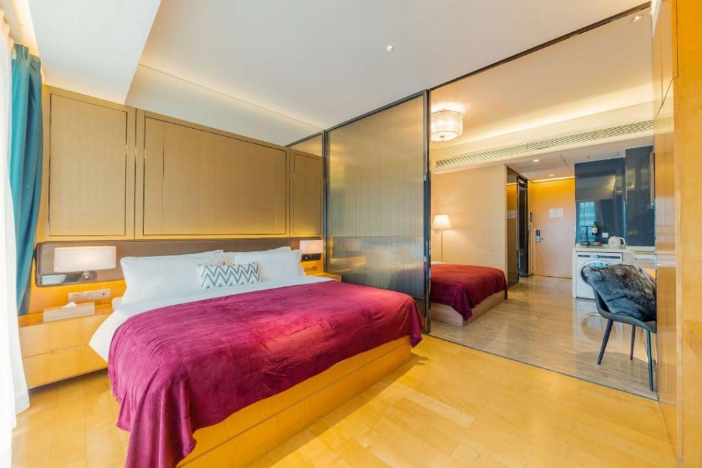 a bedroom with a large bed and a bathroom at Fa万濠国际服务公寓 in Guangzhou