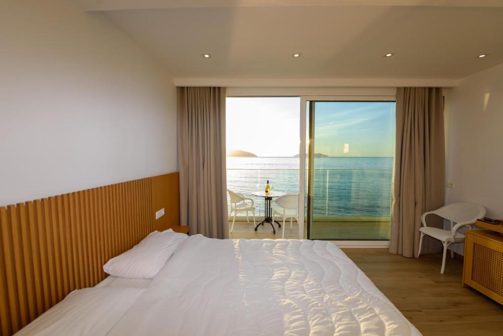 Postel nebo postele na pokoji v ubytování Hotel Nimfa