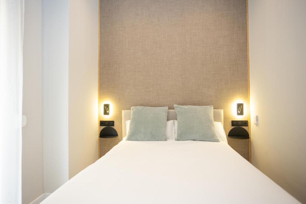 Posteľ alebo postele v izbe v ubytovaní Chinitas Urban Rooms