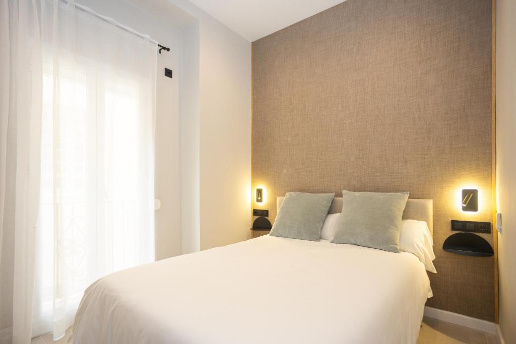 Posteľ alebo postele v izbe v ubytovaní Chinitas Urban Rooms