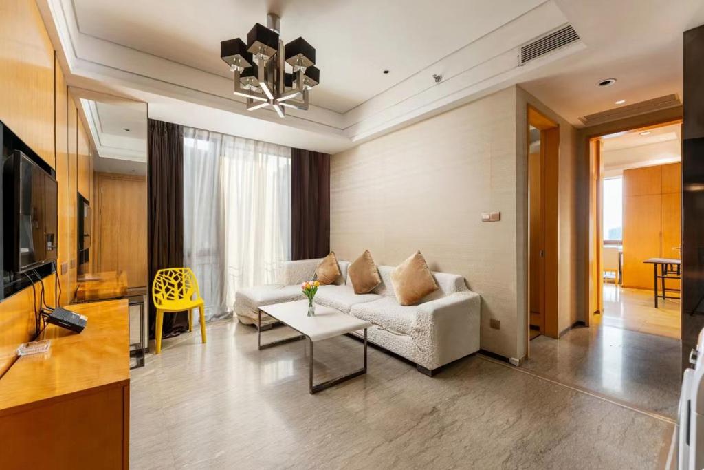 a living room with a couch and a table at Fa万濠国际服务公寓 in Guangzhou