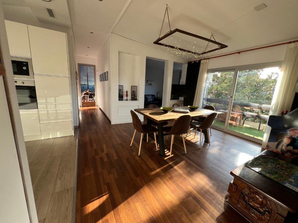 a dining room and living room with a table and chairs at Dalt Vila Salou Deluxe in Salou