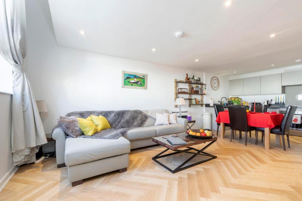 a living room with a couch and a table at Thornton House Luxury Accommodation in the Town Centre with Private Parking in Cheltenham