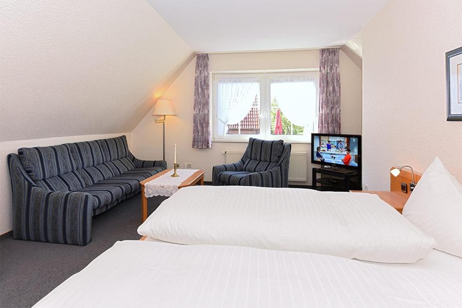Postel nebo postele na pokoji v ubytování Hotel garni Poggenstool