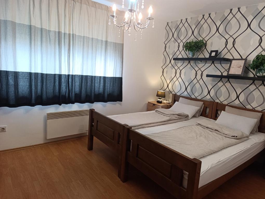 a bedroom with two beds and a window at Apartman Tarik in Sarajevo
