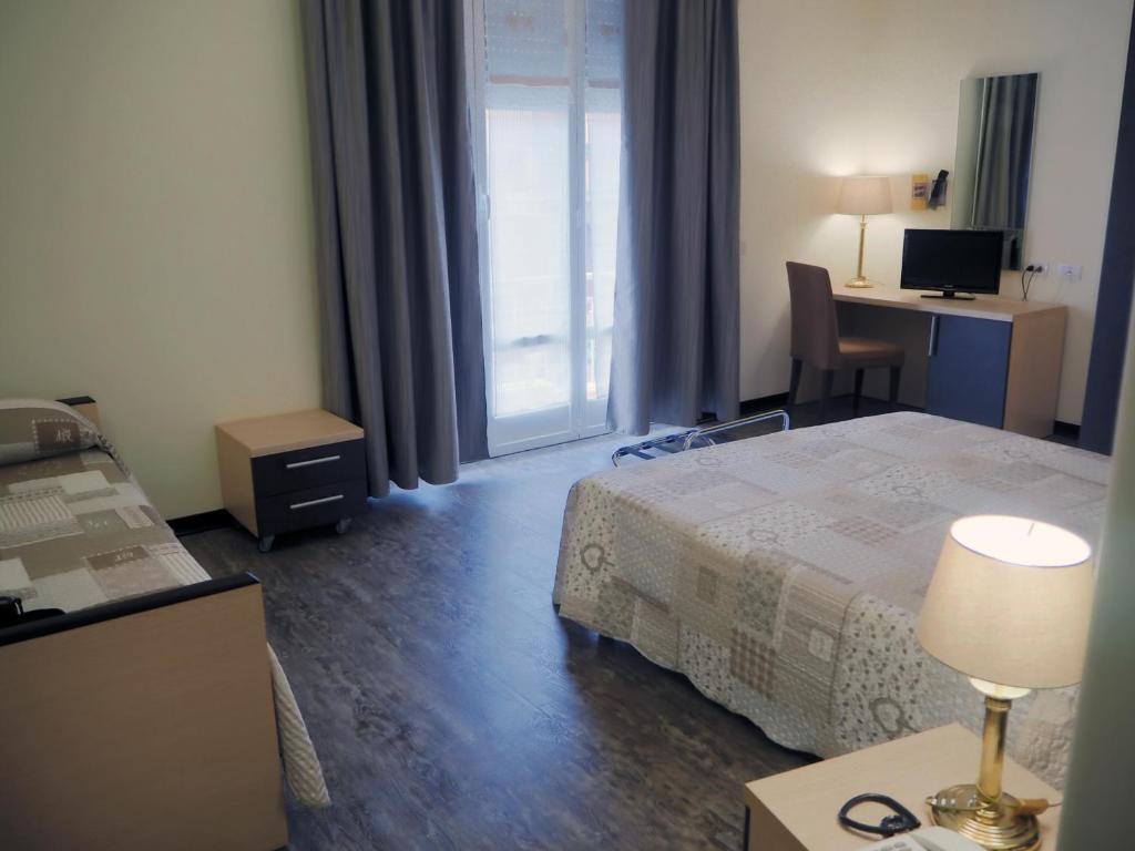 Postel nebo postele na pokoji v ubytování Hotel Ferrari