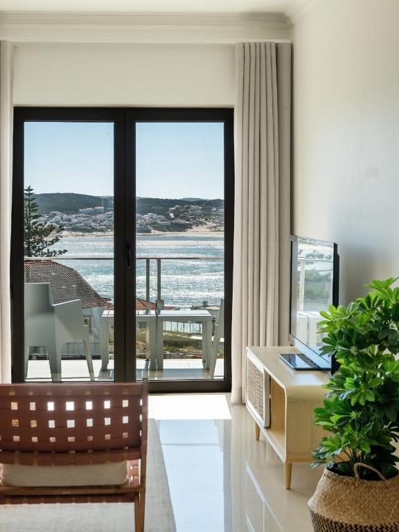 a living room with a view of the ocean at Sam's House in Foz do Arelho