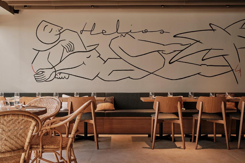 a restaurant with a mural of a person on the wall at Helios Mallorca Hotel & Apartments in Can Pastilla
