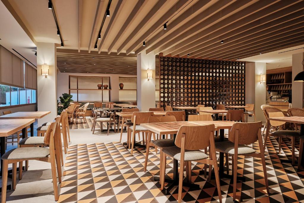 a restaurant with tables and chairs and a wall of wine bottles at Helios Mallorca Hotel & Apartments in Can Pastilla