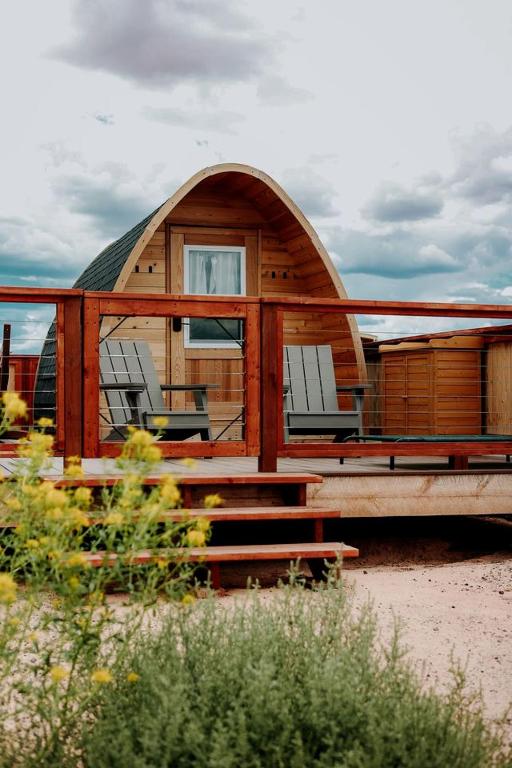 a small cabin with two chairs and a table at Cozy Glamping Pod for a Nature Escape in Monticello, Utah in Monticello