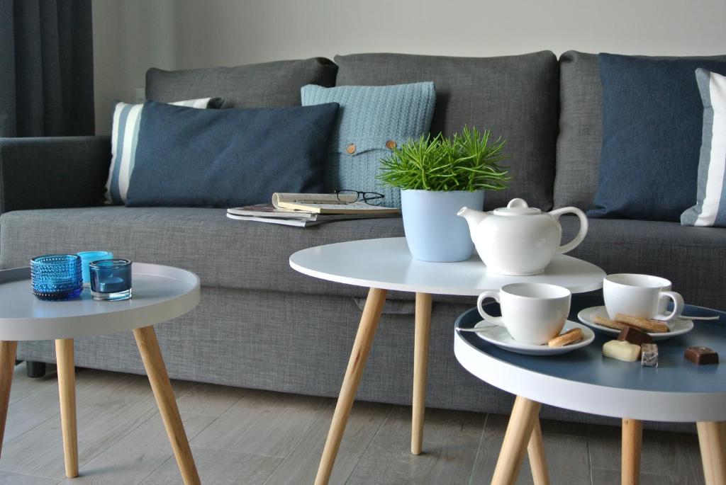 a living room with two tables and a couch at Lo-Gies in Lochristi