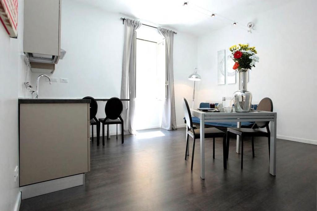 a kitchen and dining room with a table and chairs at Rome Services Borgo Suites in Rome