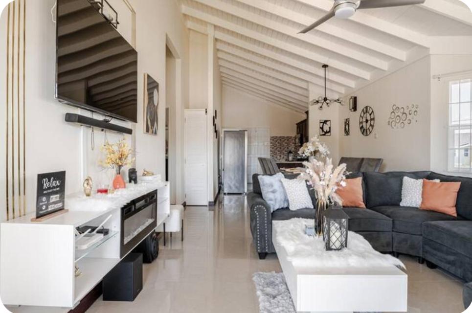 a living room with a couch and a table at Barefoot Bliss Short Term Rental with pool in Colbeck Manor in Claremont
