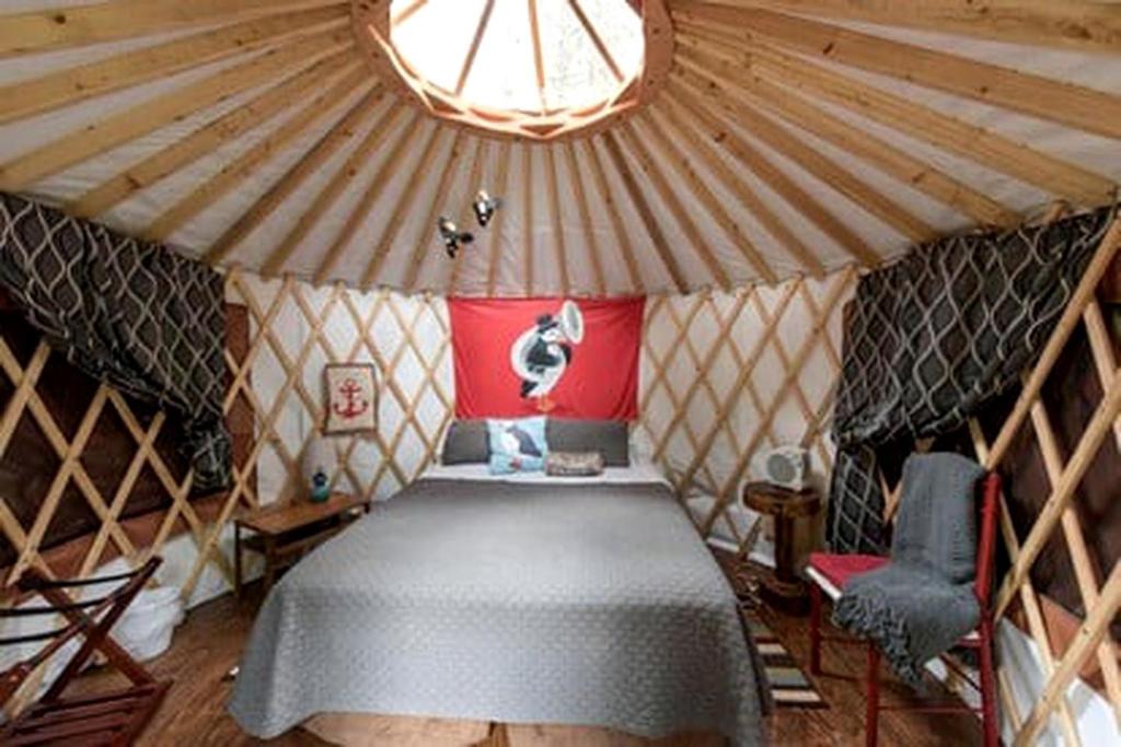 a small room with a bed in a yurt at Alaskan Yurt Glamping, Perfect for a Couples Getaway in Seward