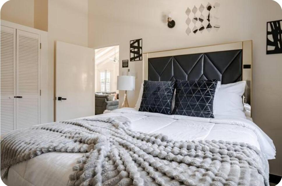 a bedroom with a large bed with a large comforter at Barefoot Bliss Short Term Rental with pool in Colbeck Manor in Claremont