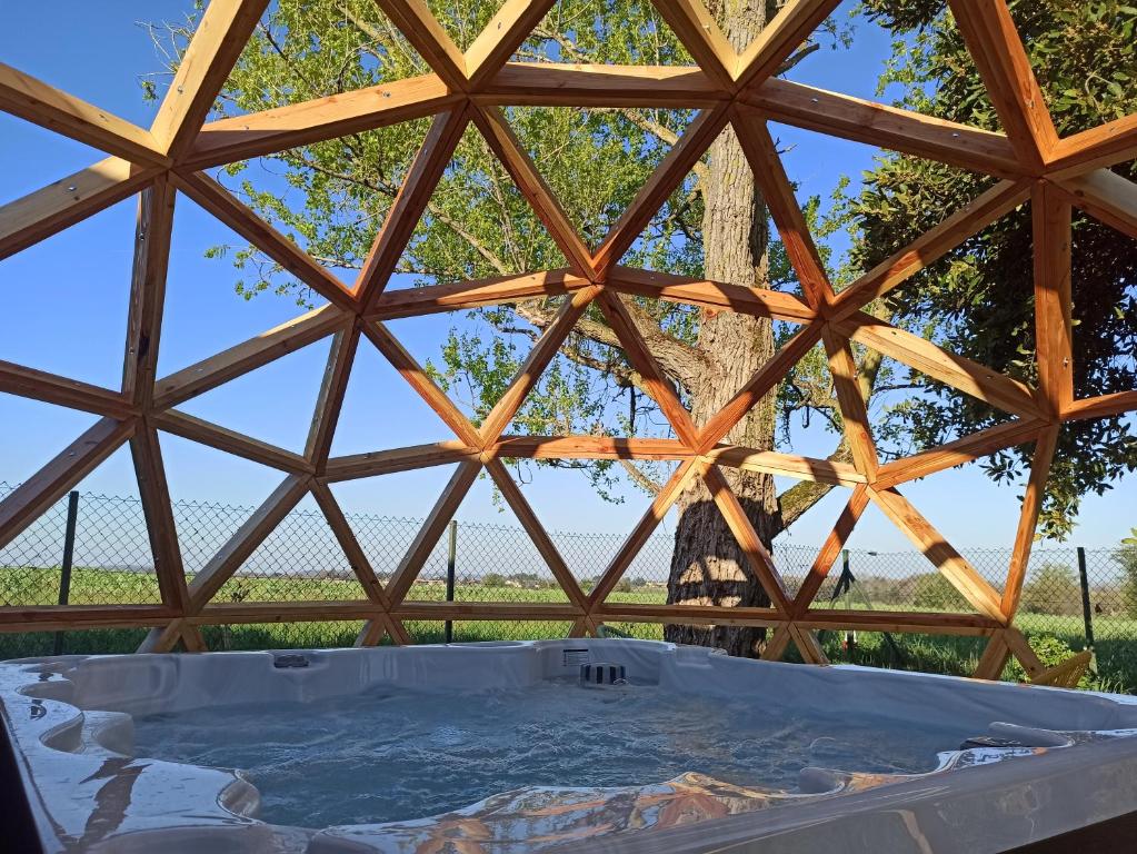 a view from the inside of a wooden roof with a hot tub at Gîte de charme et spa prés d'Albi , Au Mas de Bel Air in Arthès