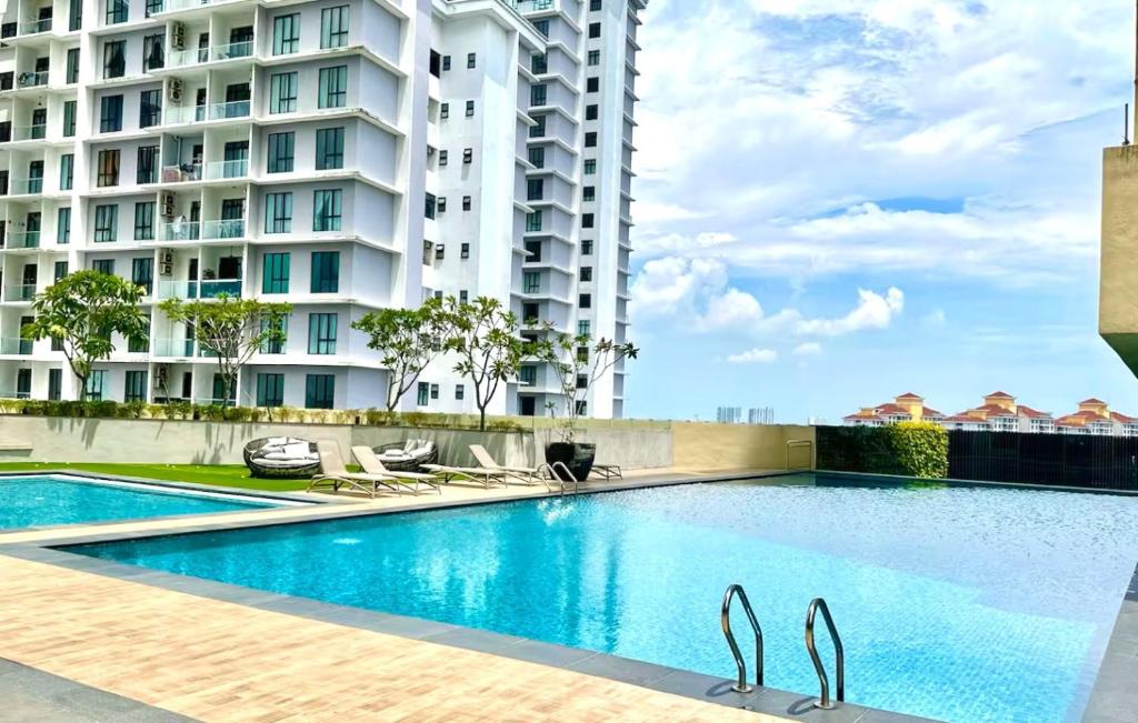 a swimming pool in front of a building at Paradigm Residence Johor Bahru in Johor Bahru