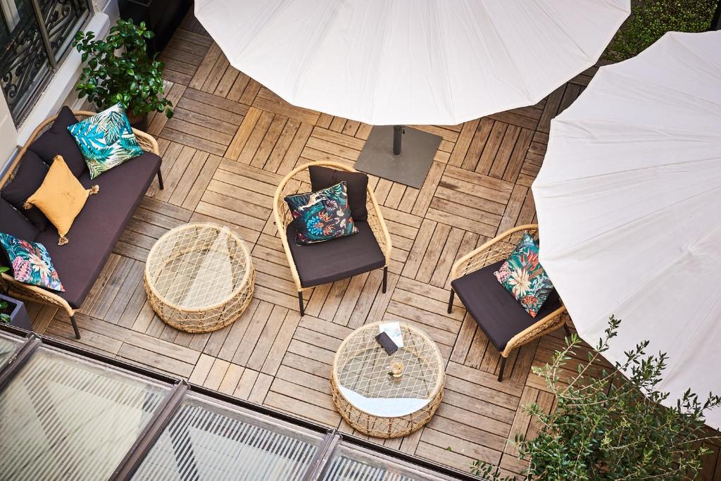 an overhead view of a patio with chairs and tables at Hotel Cervantes by Happyculture in Paris
