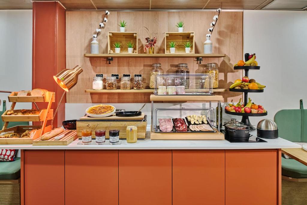 a buffet with various food items on display at Hotel Cervantes by Happyculture in Paris