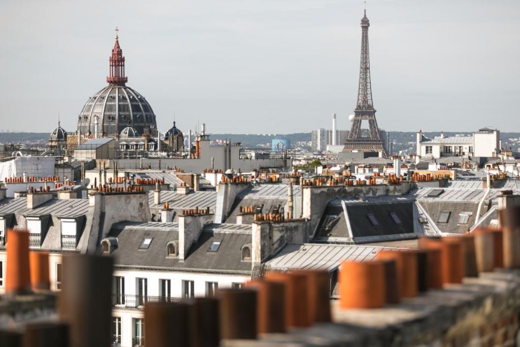 a view of a city with the eiffel tower at Hotel Cervantes by Happyculture in Paris