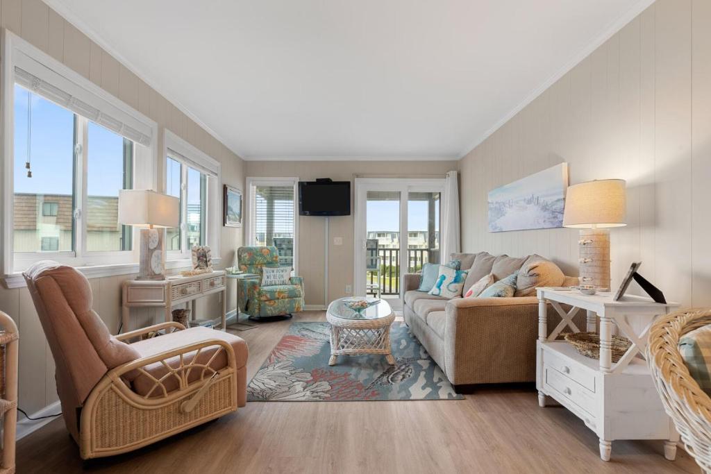 a living room with a couch and a table at Southwinds J12 condo in Atlantic Beach