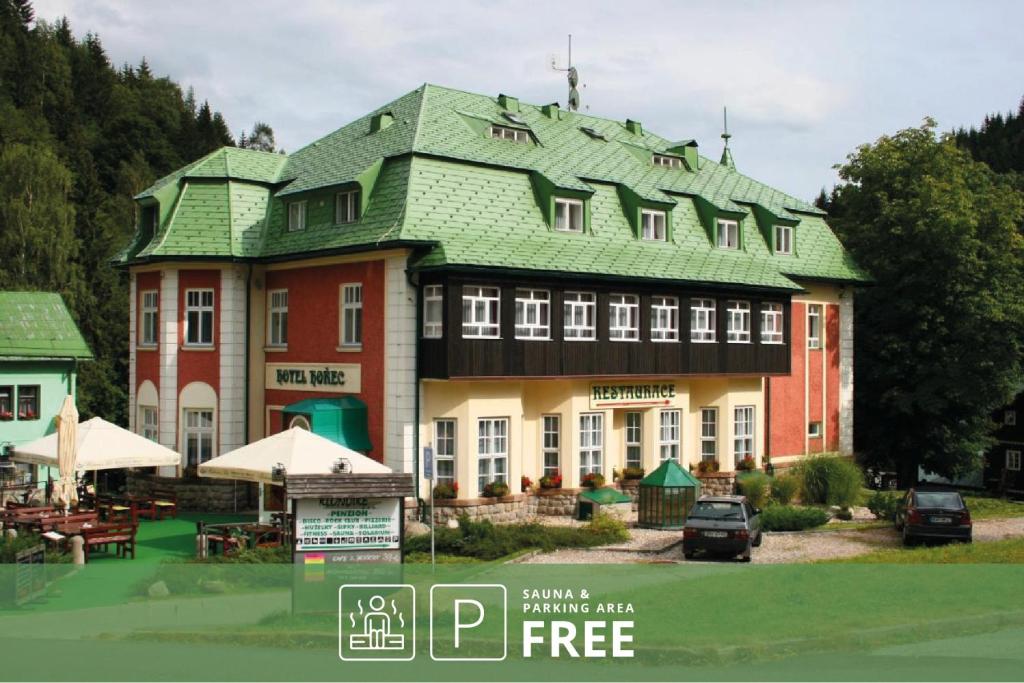 a large building with a green roof at Hotel Hořec in Pec pod Sněžkou