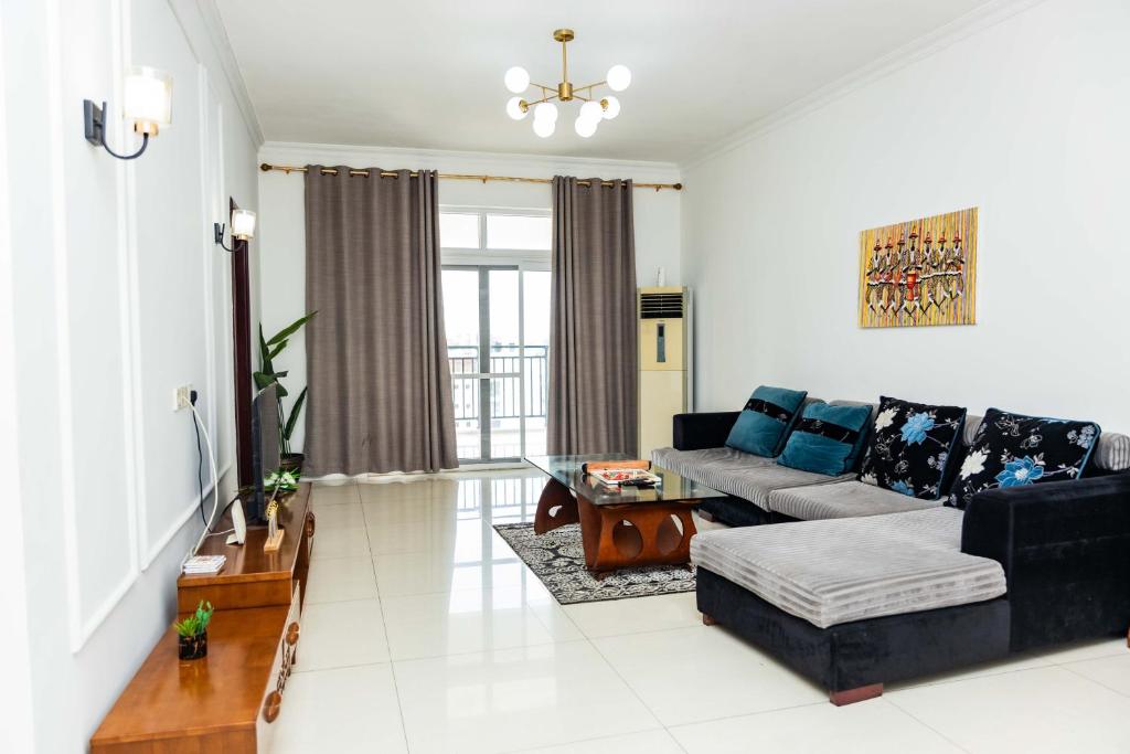 a living room with a couch and a table at Eastern Hills Apartments in Accra