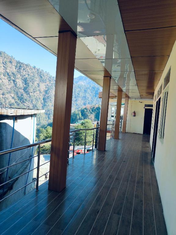 a balcony of a building with a view of a mountain at Hotel vijaya in Phata