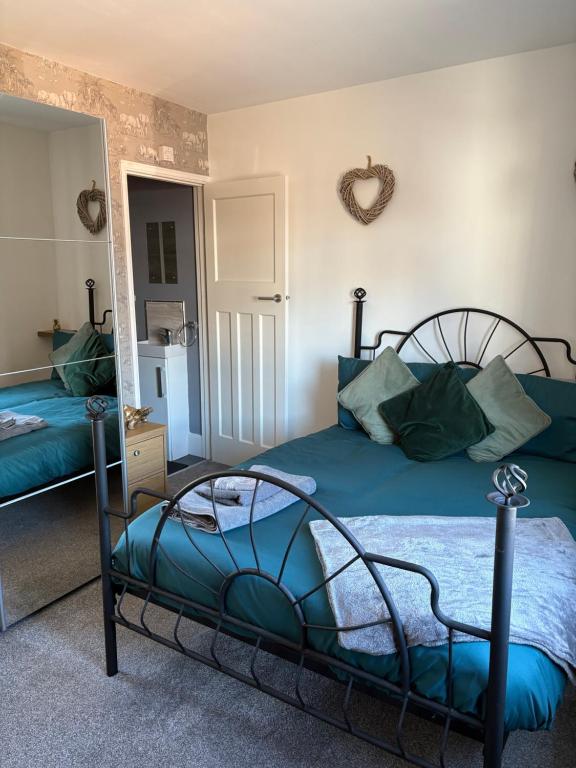 a bedroom with two beds and a mirror at Valeries House 4 Bed 2 Bath close to beach in Gorleston-on-Sea