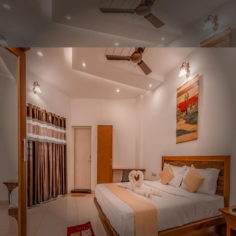 Postel nebo postele na pokoji v ubytování Prashanth Residency Madikeri