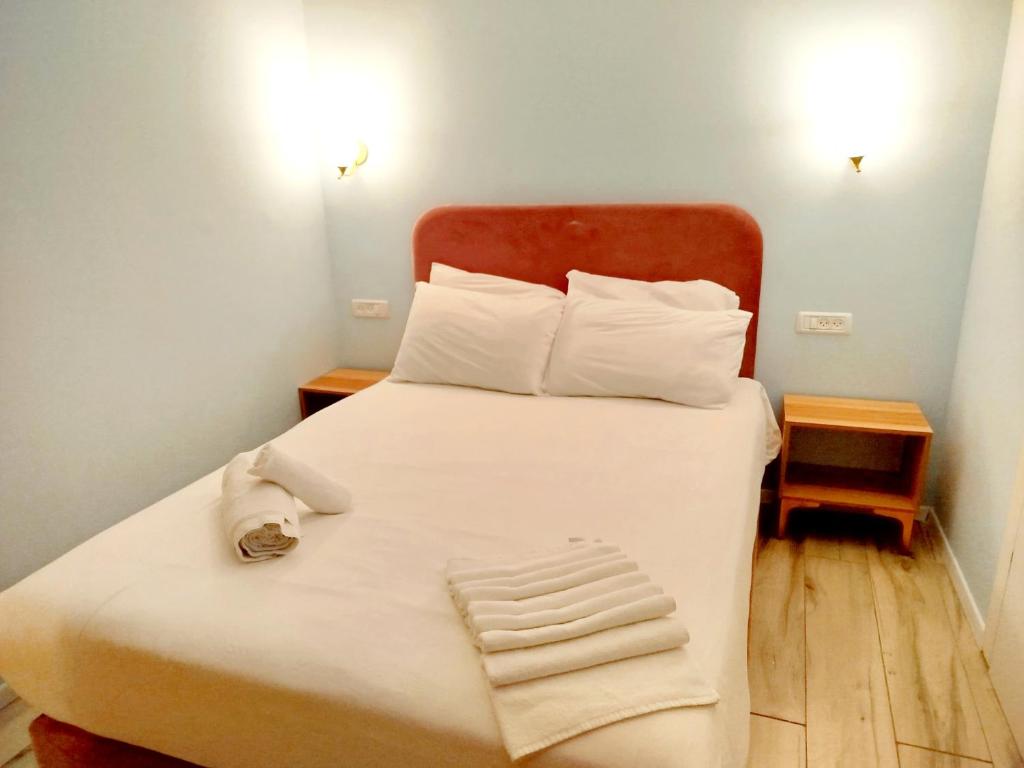 Postel nebo postele na pokoji v ubytování La Perle City Center Rooms