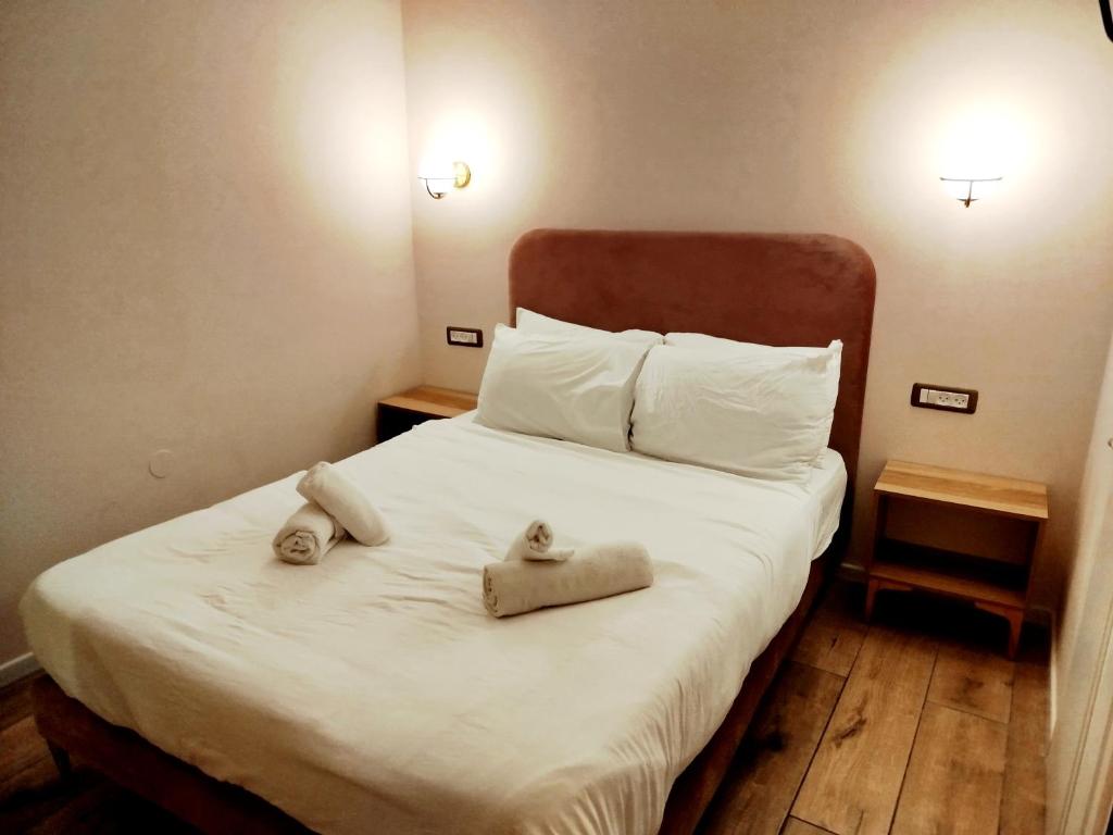Postel nebo postele na pokoji v ubytování La Perle City Center Rooms