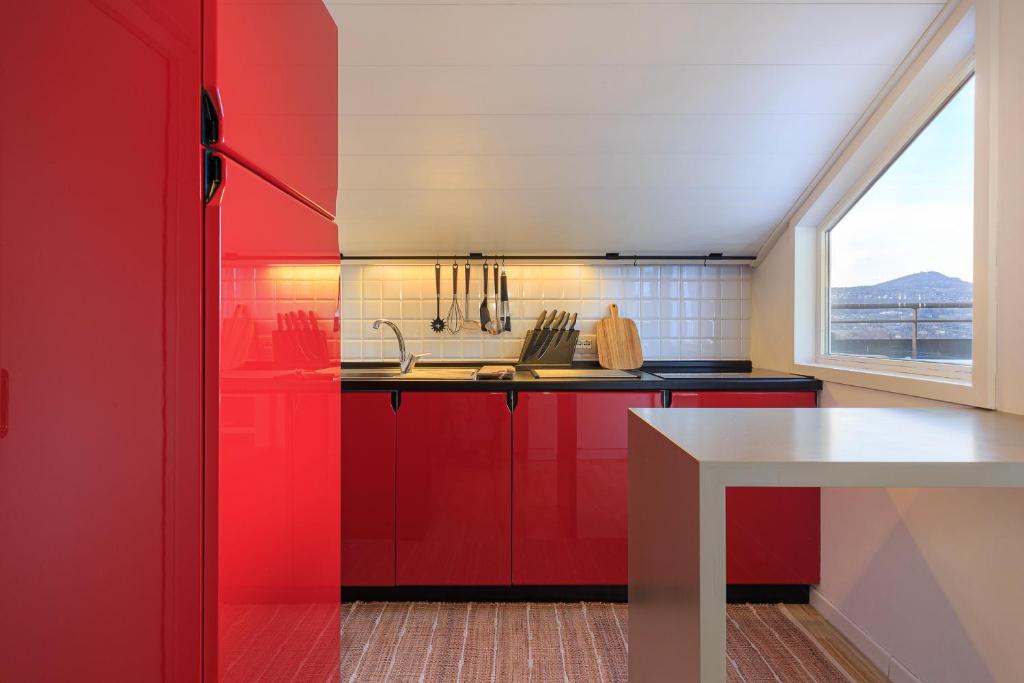 a kitchen with red cabinets and a window at Casa Giacomo in Arona