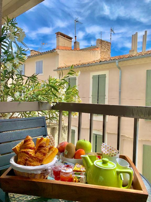 a tray of food on a table on a balcony at Hotel Des Tuileries in Nîmes