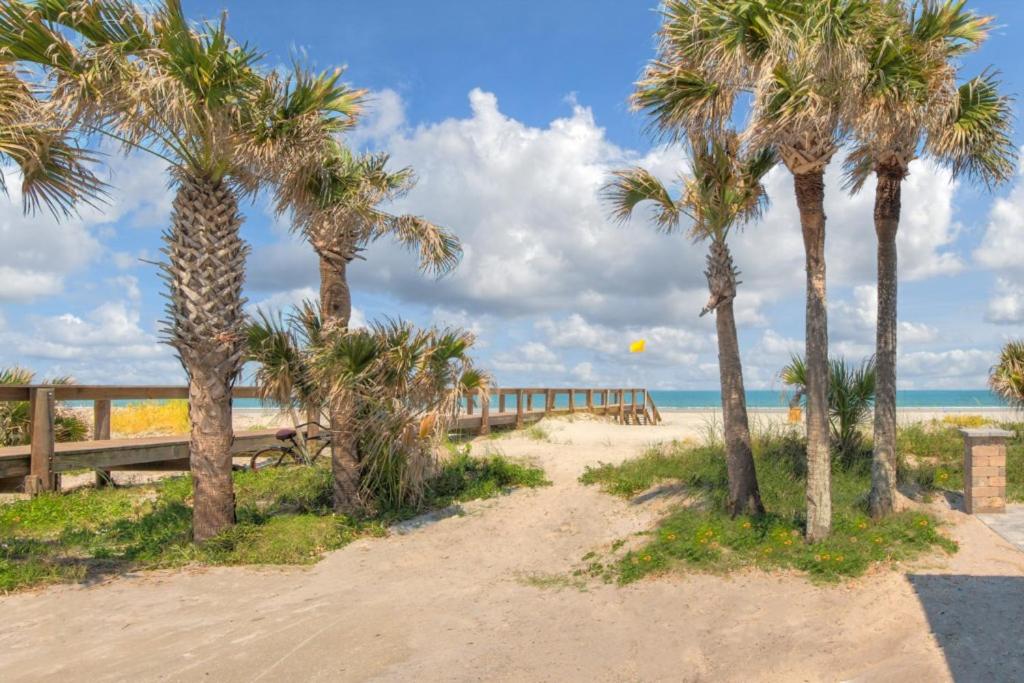 a path to the beach with palm trees at A Wave From It All Oceanview 2Nd Level Patio in Jacksonville Beach