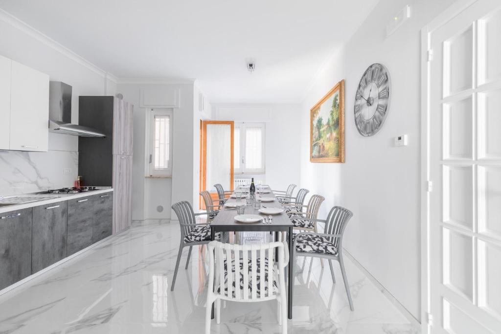 a kitchen and dining room with a table and chairs at House White Puglia by BarbarHouse in Fasano