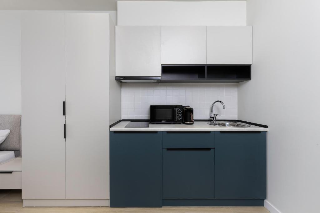 Kuchyň nebo kuchyňský kout v ubytování Next Apartments OFFICIAL