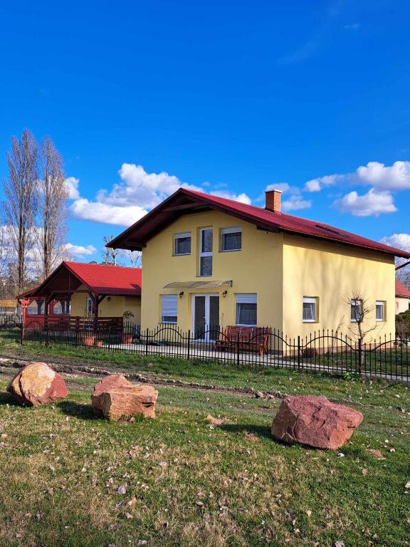 a house with two rocks in front of it at PontyParádé in Fonyód
