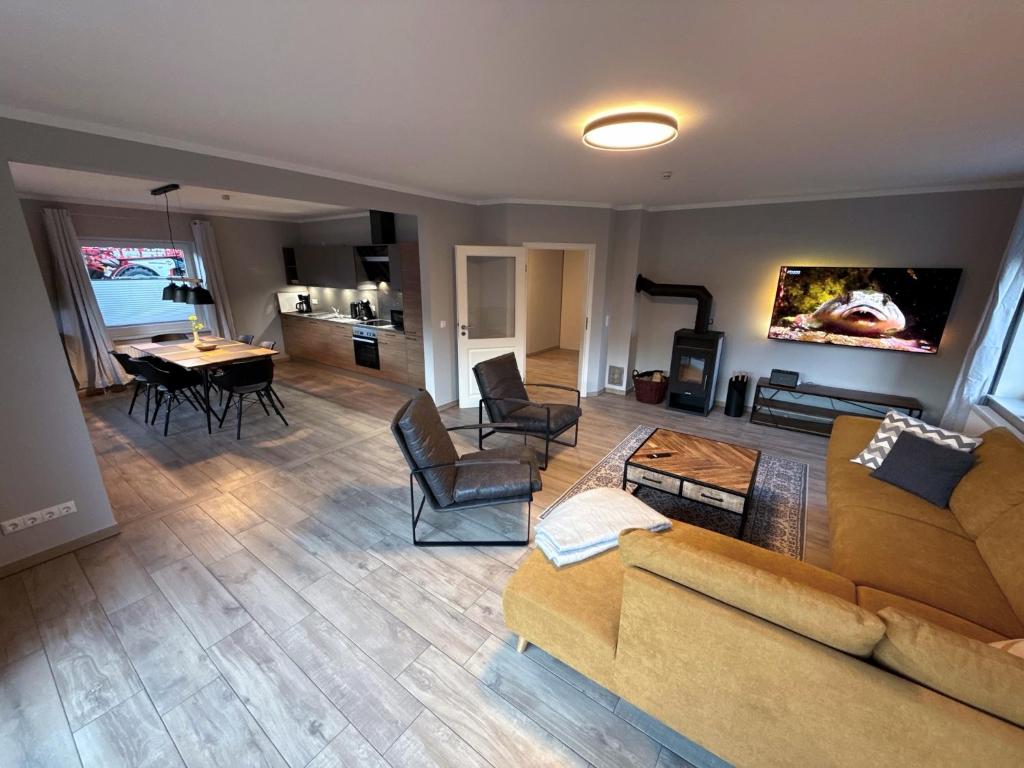 a living room with a couch and a table at Bauernhof Claussen Fehmarn in Fehmarn