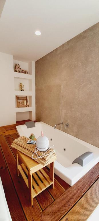 a bath tub in a room with a table at BARBARA Classy Apartments 103, Wellness in Siracusa