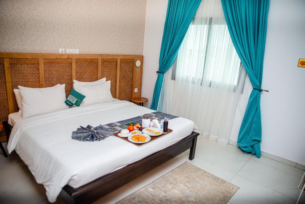 Postel nebo postele na pokoji v ubytování Hotel Yatchenin Abidjan