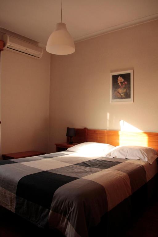 Postel nebo postele na pokoji v ubytování Residencial Dom Manuel