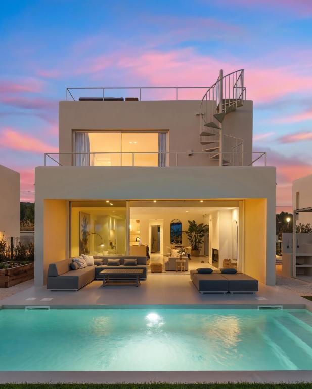 a house with a swimming pool in front of it at Modern Sea View Villa, Heated Pool,Rooftop Jacuzzi Outdoor Kitchen 12min faro Airport in Santa Bárbara de Nexe