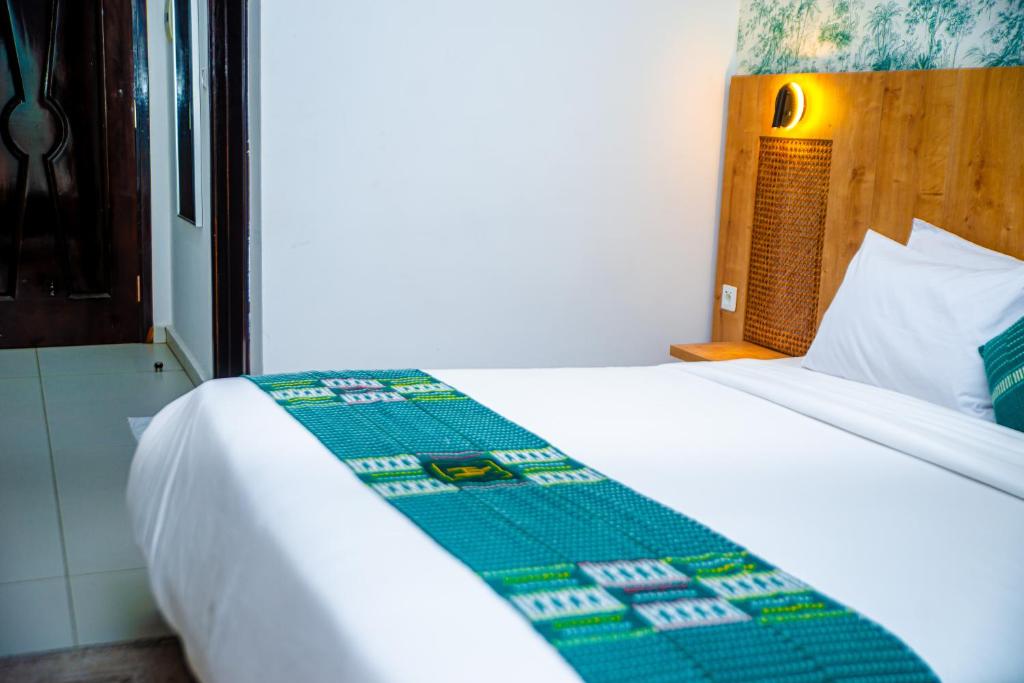 Postel nebo postele na pokoji v ubytování Hotel Yatchenin Abidjan