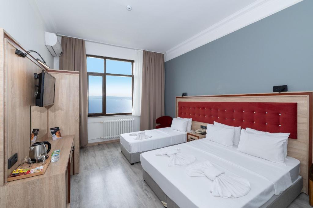 Postel nebo postele na pokoji v ubytování Olimpic Hotel