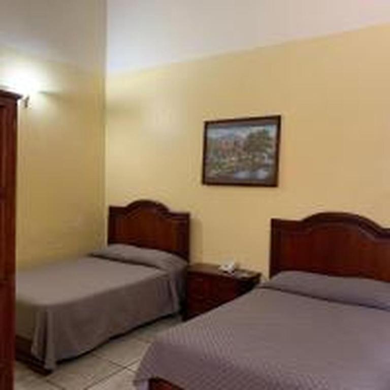Postel nebo postele na pokoji v ubytování OYO Hotel Real de Cortés