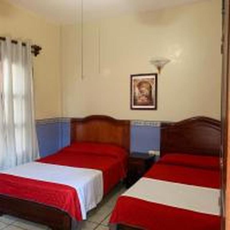 Postel nebo postele na pokoji v ubytování OYO Hotel Real de Cortés