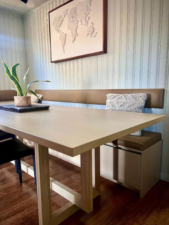 a wooden table in a room with a chair at SandyCove04 in Shoal Cove
