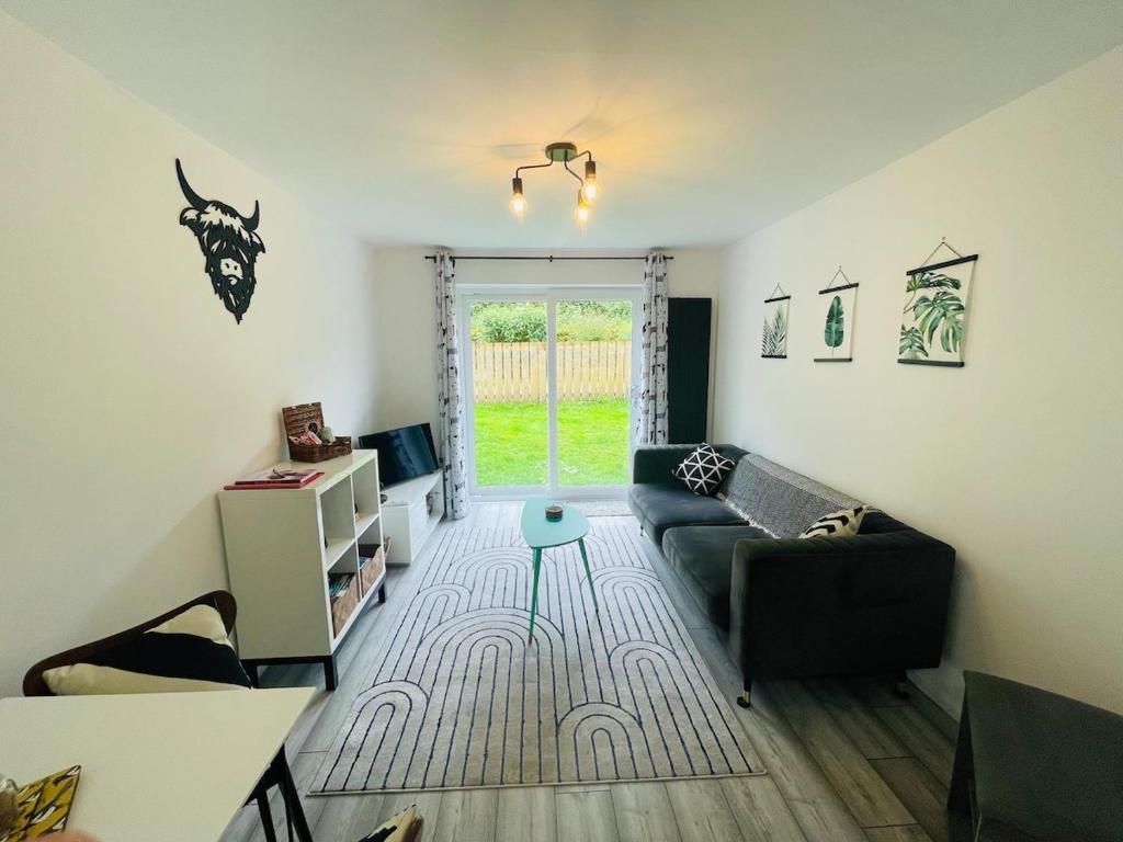 a living room with a couch and a table at Cosy & Chic Dog Friendly Apartment, Settle in Settle